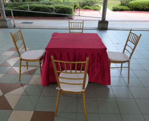 Red cloth square table paired with tiffany chairs