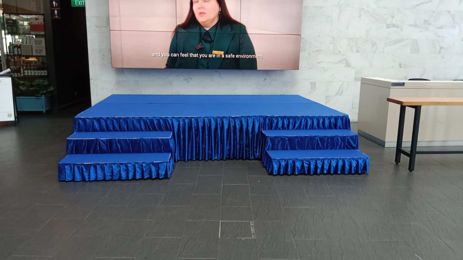 Blue stage with 2 sets of stairs